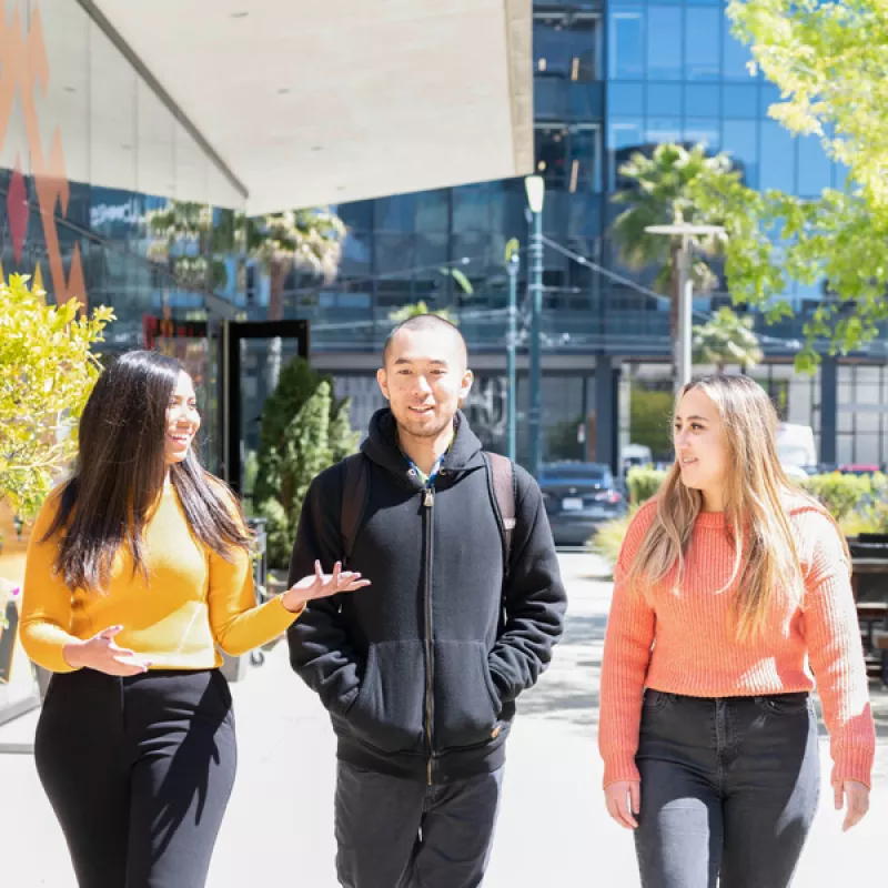 three students walk together at Mission Bay campus