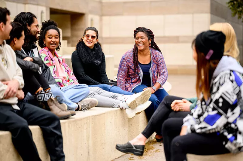 Dr. D'Anne Duncan (center) chats with several students who've participated in the GRAD 210 course
