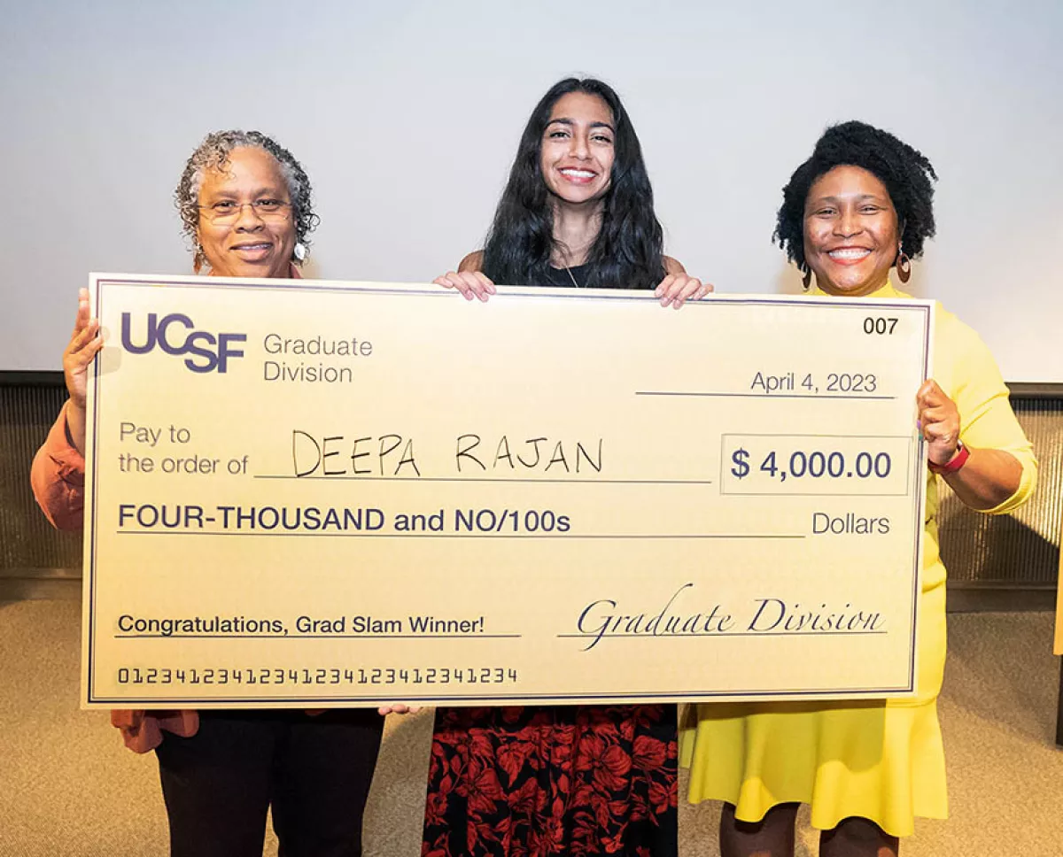 Deepa Rajan holding an oversized check
