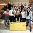 Sophia Miliotis, 1st prize winner of 2025 UCSF Grad Slam, poses with giant check, flanked by fellow students and colleagues