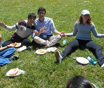 Students sitting on the grass eating