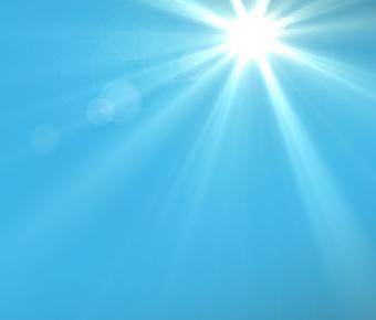 photo of bright sun with streaming rays in a blue sky