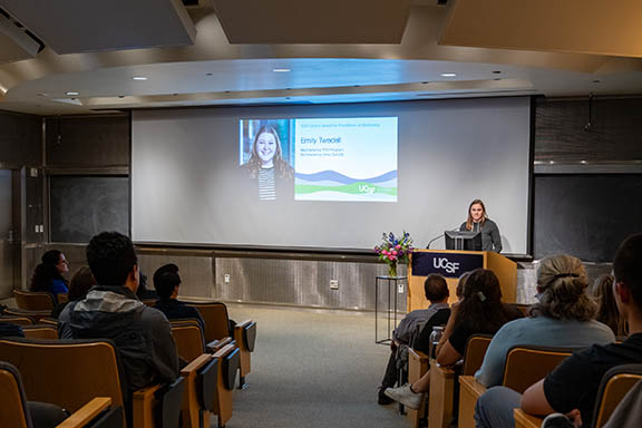 nominator Olivia Barnhill offers remarks about awardee Emily Twedell while audience looks on