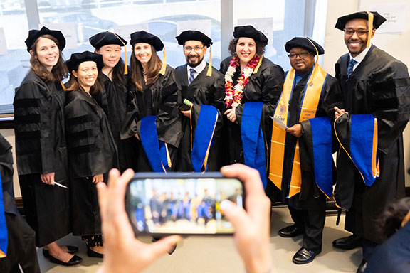 Epidemiology and Translational Science PhD grads gather for a photo in commencement regalia