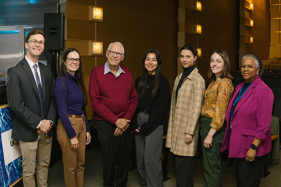 Discovery Fellows symposium speakers pose for a photo with donor Roger Page and Dean Nicquet Blake