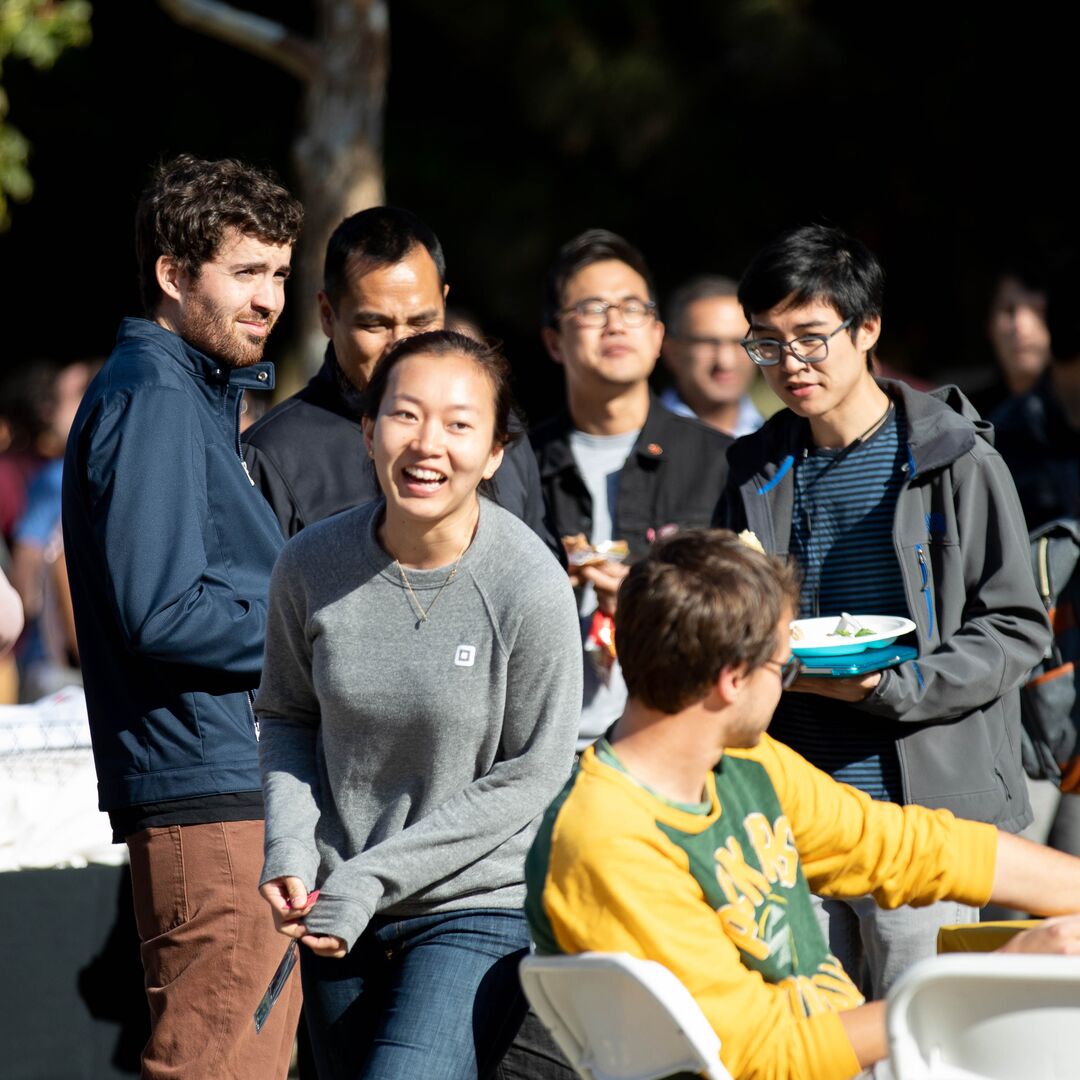 A group of new UCSF students smiling at an outdoor event