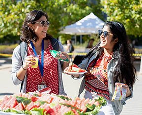 Two students enjoy the buffet at Graduate Division Fall Celebration