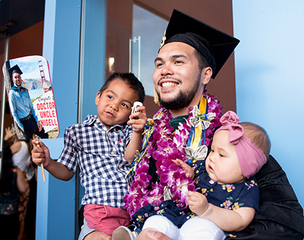 A DPT graduate with young nephew and niece at reception on June 10