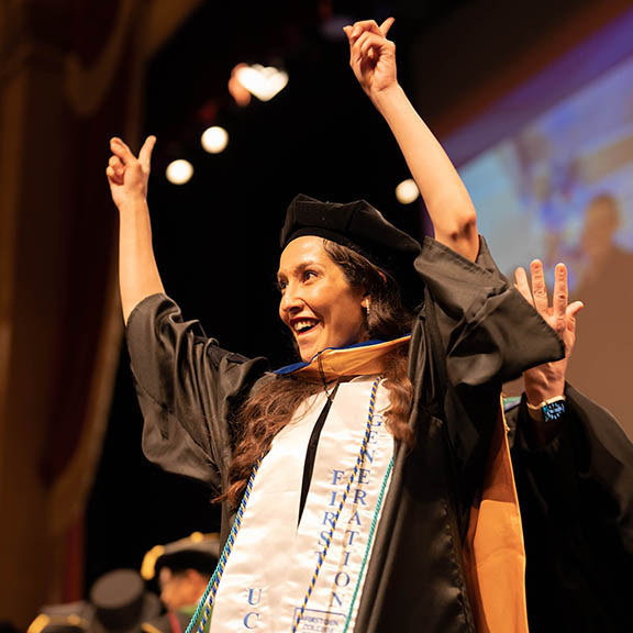 A graduate celebrates at commencement