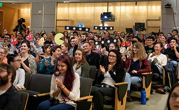 Audience for 2019 Postdoc Slam cheers finalists on.