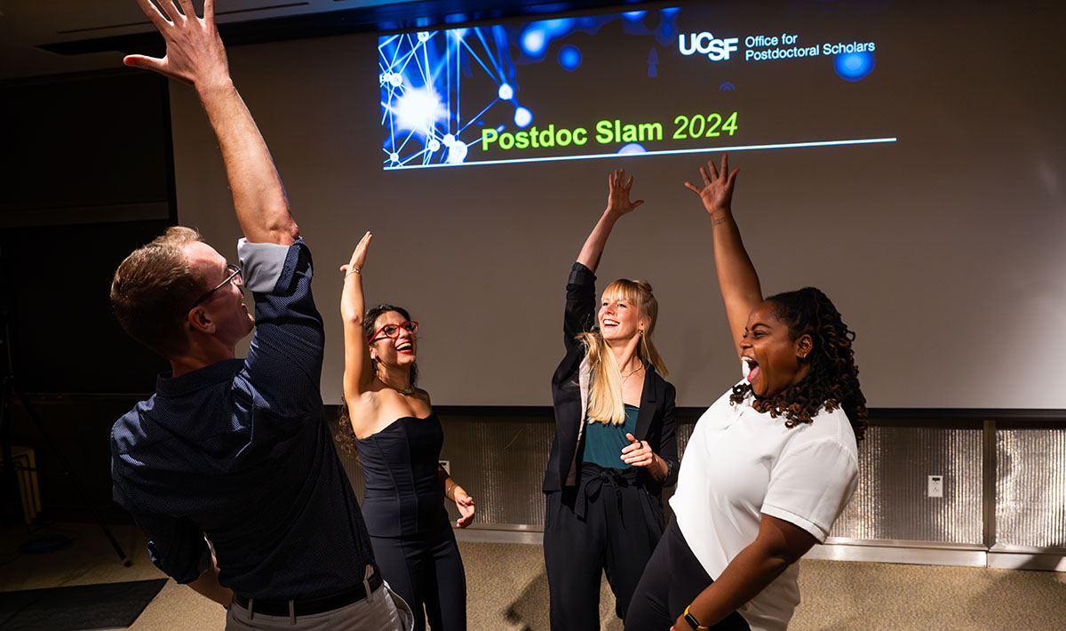 Four Postdoc Slam prize winners celebrate together